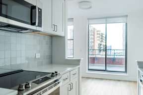 a kitchen with a window and a stove and a microwave