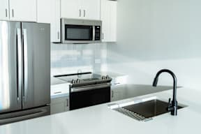 a kitchen with a sink and a refrigerator