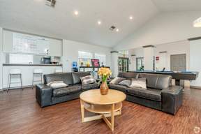 a living room with leather couches and a coffee table