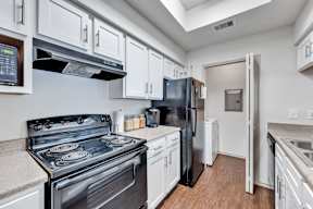 a kitchen with stainless steel appliances and white cabinets