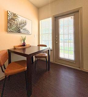 A dining room with a wooden table and chairs.