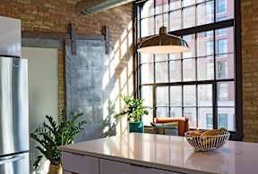 A kitchen with a large window and a bowl on the counter.