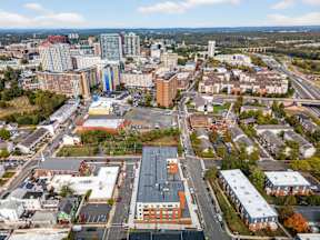 A cityscape with a mix of residential and commercial buildings.