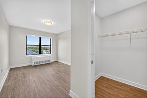 Empty room with a window and a radiator.