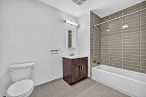 A white toilet sits next to a sink in a bathroom.