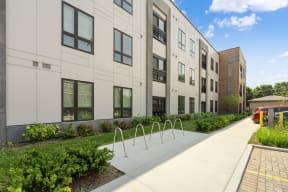 a large white building with a sidewalk in front of it