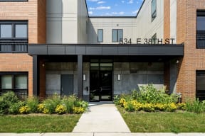 the front of a building with a sidewalk in front of it