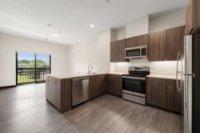 a kitchen with wooden cabinets and stainless steel appliances