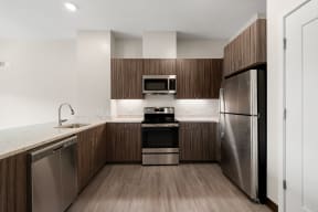 a kitchen with wooden cabinets and stainless steel appliances