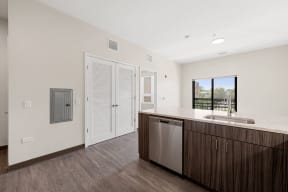 a kitchen with a sink and a door to a balcony