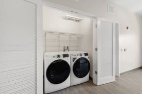 a washer and dryer in a laundry room with a closet