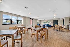 A large room with tables and chairs.