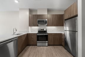 a kitchen with wooden cabinets and stainless steel appliances