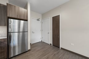 a kitchen with a stainless steel refrigerator and a door to a closet