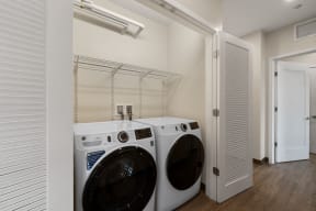 a washer and dryer in a laundry room with a closet