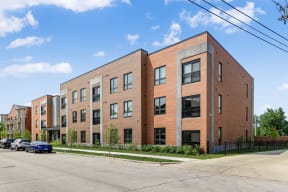 a brick apartment building on the corner of a street