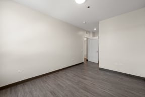 a living room with white walls and wood floors