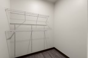 a empty closet with wire shelving on the wall