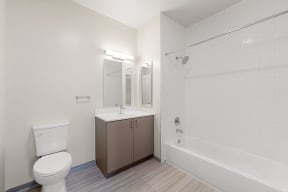 a bathroom with a toilet sink and tub and a mirror
