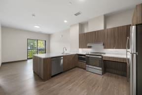 a kitchen with wooden cabinets and stainless steel appliances