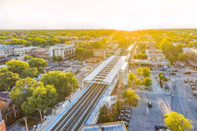 an aerial view of a city with train tracks