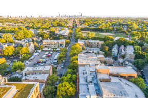 an aerial view of the city with trees and buildings