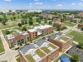 an aerial view of a city with plants growing on the roofs of buildings