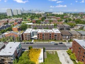 an aerial view of an urban neighbourhood with a city in the background