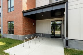 the entrance to a building with a ramp and a glass door