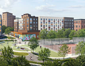 A playground with a basketball court and a mural on a building.