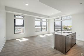 A kitchen area with a counter and cabinets is shown in the image.