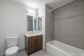 A bathroom with a toilet, sink, and bathtub.