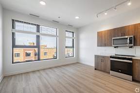A kitchen with a microwave and oven on top of a counter.
