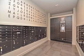 A wall of mailboxes with a wall of letters above them.