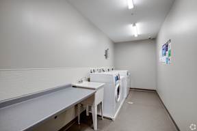 A laundry room with a washer and dryer stacked on top of each other.