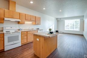 A kitchen with wooden cabinets and a white stove top oven.