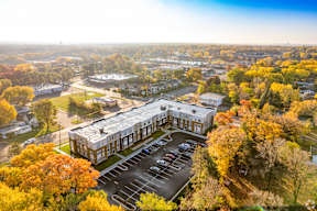 A parking lot is in front of a large building.
