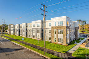 A street view of a residential area with apartment buildings.
