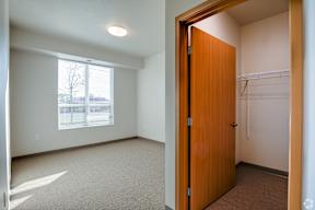 A room with a brown door and a window.