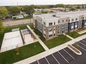 A large building with a parking lot in front of it.
