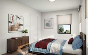 A bedroom with a bed, nightstand, and artwork on the wall.