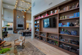 a living room with a large book shelf and a television