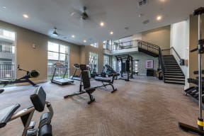 spacious gym with cardio machines and weights at the oxford condos tx