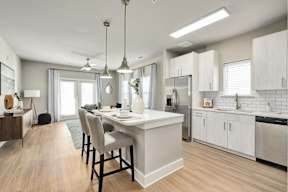 A modern kitchen with a dining table and chairs.