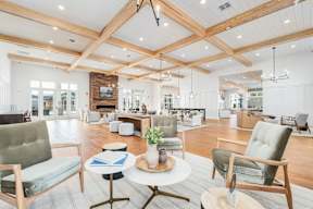 A living room with a grey couch, a white coffee table, and a wooden floor.