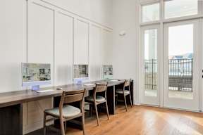 A room with a table and chairs and pictures on the wall.
