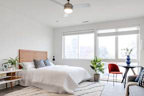 a bedroom with a bed and a ceiling fan