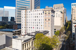 an aerial view of a white building in the city