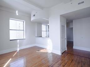 an empty living room with white walls and wood floors