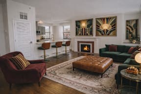 A living room with a fireplace and a red chair.